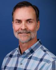 head and shoulders photograph of middle-aged white man with beard