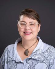 smiling white woman with cool glasses.